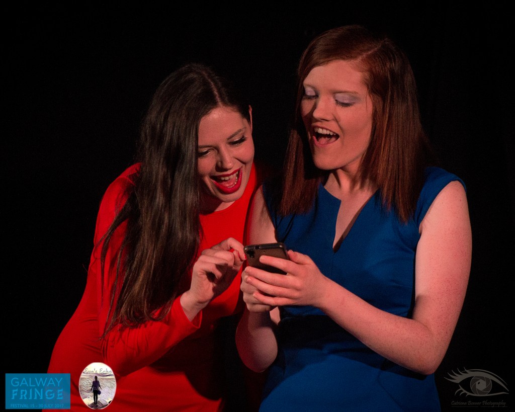 Two women dressed in red and blue on phone