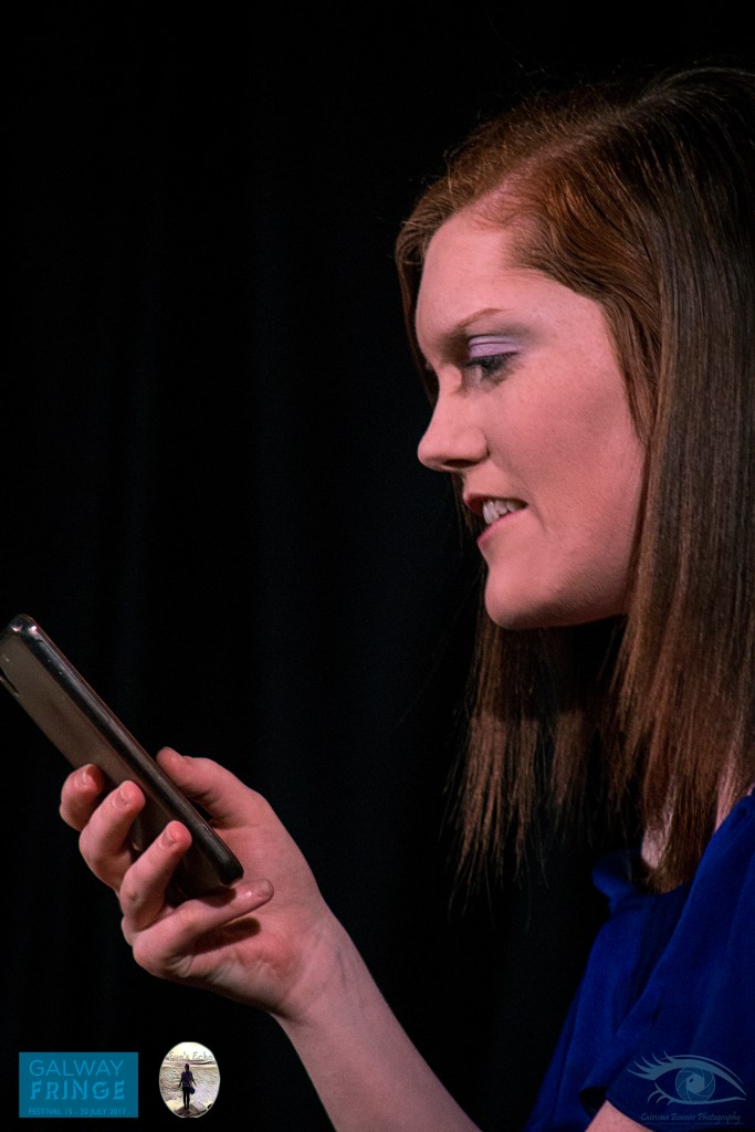Actor Elizabeth Flaherty looking at phone