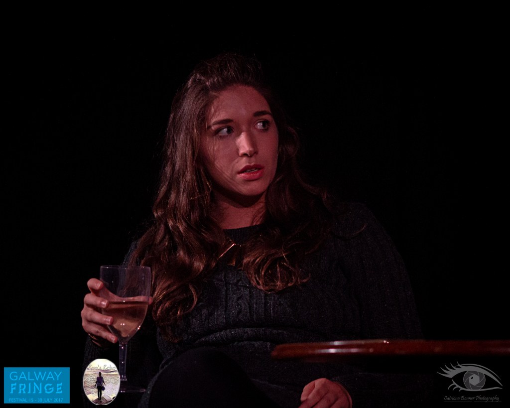 Actor Hazel Doolan drinking wine on stage