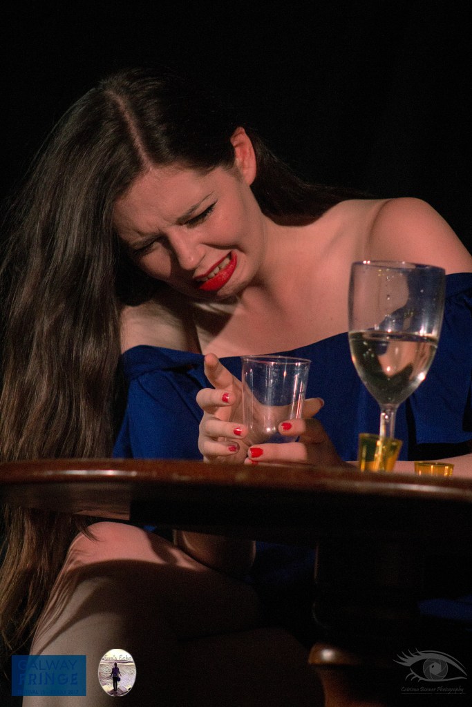 Actor making disgusted expression drinking wine